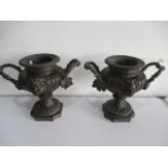 A pair of Victorian wine coolers decorated with masks of Bacchus, the handles formed of trailing