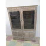 A glazed display/book case with cupboard under
