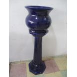 A dark blue glazed jardinière on pedestal stand