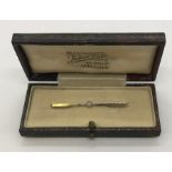 A 9ct gold bar brooch set with a seed pearl. Weight 1.7g