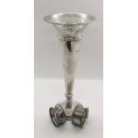 A large silver trumpet vase and two serviette rings.