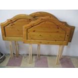 A pine double bed head along with a pair of pine single head boards