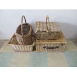 A collection of four wicker baskets