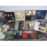 A collection of 12" vinyl records including Queen, Pink Floyd, Supertramp, The Rolling Stones, The