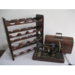 A vintage Singer sewing machine in case, along with a wine rack