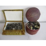 A collection of various buttons in leather collar box along with metal Christmas tree candle