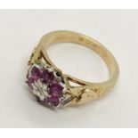 A dress ring set with a cluster of garnets in unmarked gold, size N