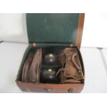A Jaques lawn bowls set with two pairs of bowls along with canvas holder, bowling shoes, measuring