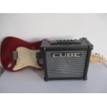 A Squire Stratocaster electric guitar along with a Roland Cube amp ( international plug and