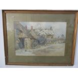 A watercolour of a thatched cottage signed R W Cox