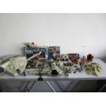 A collection of Star Wars toys (including the Millennium Falcon, Speeders, Jedi Starfighter and