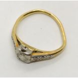 A misshapen diamond ring set in unmarked gold