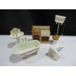 A collection of dolls house bathroom items including a claw foot bath, vanity unit, toilet with