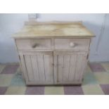 A reclaimed pine dresser base with two drawers and two cupboards under