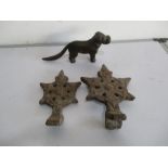 Two cast iron roof finials, along with a novelty cast iron nut cracker in the form of a dog