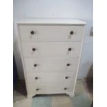 A white painted chest of five drawers