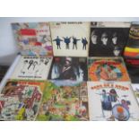 A small collection of 12" vinyl records including The Beatles, Beach Boys, ELO etc, along with
