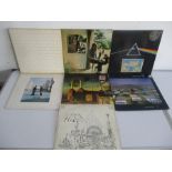 A collection of seven Pink Floyd vinyl records including albums Dark Side Of The Moon, Animals,