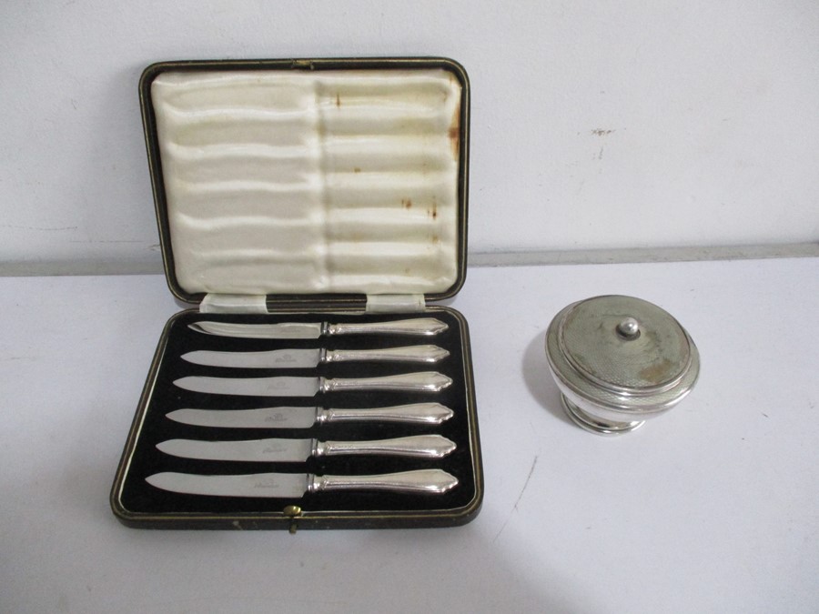 A cased set of knives with hallmarked silver handles, along with a hallmarked silver pot with