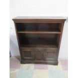 An oak bookcase with cupboard under