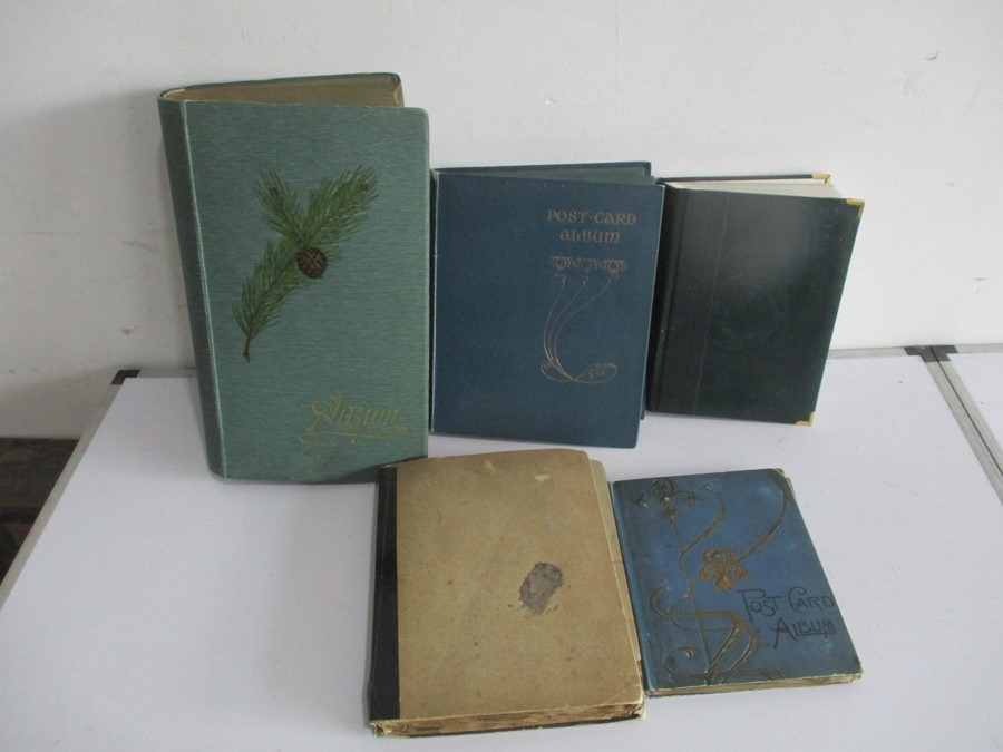 A large collection of postcards in five albums