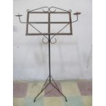 A wrought iron music stand with candelabra