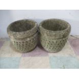 A pair of concrete garden pots