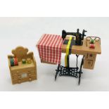 A dolls house treadle sewing machine and a sewing box