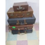 A collection of five vintage suitcases