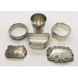 Three silver serviette rings along with two silver Sherry labels etc, approx 86g total weight