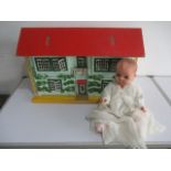 A vintage dolls house with a selection of furniture included, along with a baby doll