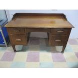 A c1920 office desk with five drawers to include two filing drawers