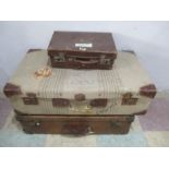 Two vintage suitcases along with a small case