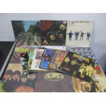A collection of seven 12" vinyl records by The Beatles including first pressings, along with seven