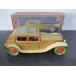A boxed Wells, London clockwork tinplate Saloon car, lithographed beige with cream and red lining,