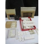 A collection of dolls house plaster architectural mouldings including pillars and columns along with