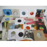 A collection of 7" vinyl singles including John Lennon, Elvis Presley, Jethro Tull, Fleetwood Mac,