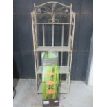 A set of ornate metal shelves along with a boxed bamboo tiered shelf unit