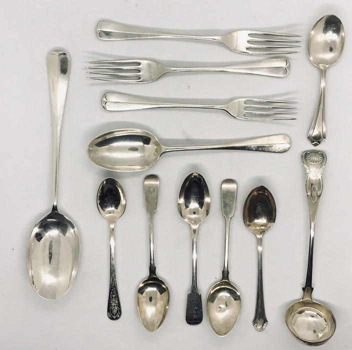 A collection of hallmarked silver cutlery including a Georgian rat tail spoon, ladle etc. Total