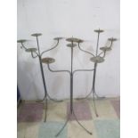 A set of three wrought iron three branch candelabra