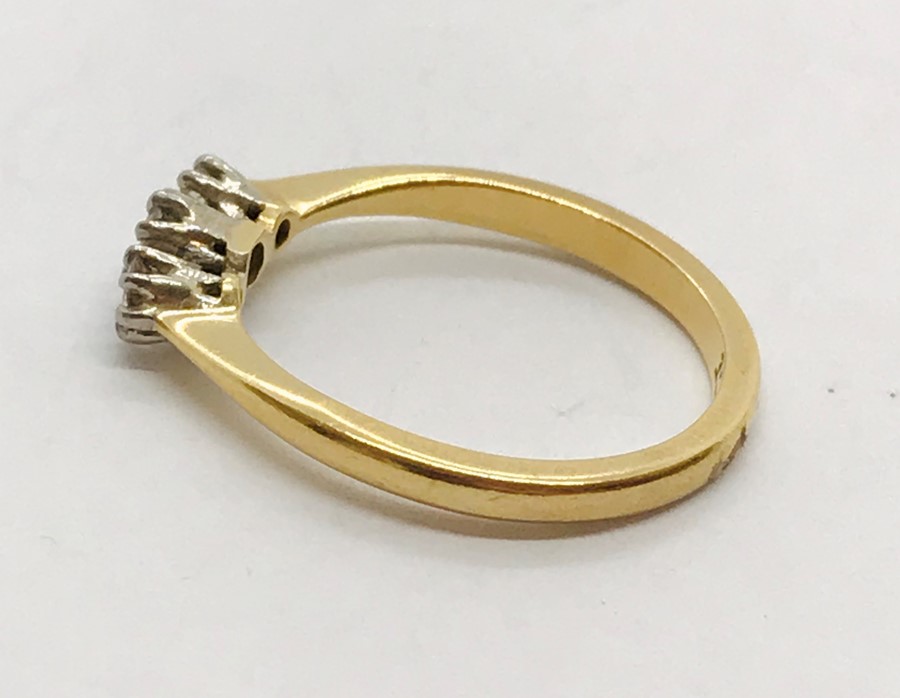 An 18ct gold ring with three diamonds