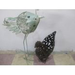 A metal figure of a chicken along with a wirework figure of a bird