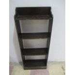 A narrow stained freestanding bookcase