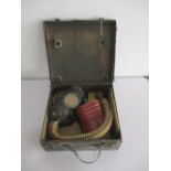 A WW2 cased gas mask with accessories including eyeshields, tinned ointments etc