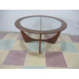 A G-Plan teak circular glass top coffee table on four conjoined supports - 84cm diameter