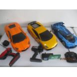 A collection of three remote control cars, including Lamborghini's by Eztec & Jianfengyuan Toys