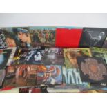 A large collection of 12" vinyl records including The Rolling Stones, The Beatles, The Eagles,
