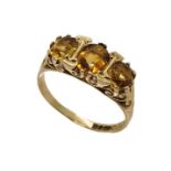 A 9ct gold trilogy ring set with citrines, size N