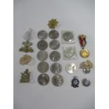 A collection of commemorative coins, along with cap badges, hallmarked silver Central Nursing