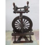 An antique double flyer spinning wheel